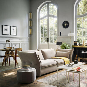 VItra Mariposa Sofa by Barber Osgerby in room with Prouvé Gueridon Table and Standard Chairs