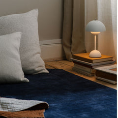 VP9 Flowerpot Lamp Matte Light Grey with Books, rug, and Floor Pillows