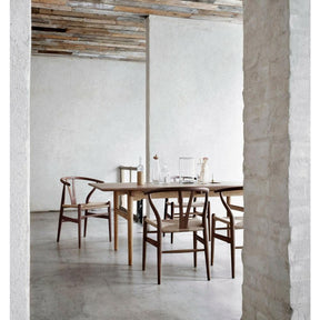Walnut Wegner Wishbone Chairs in Rustic Room