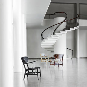 Wegner CH22 Chairs in Room with Staircase Carl Hansen and Son