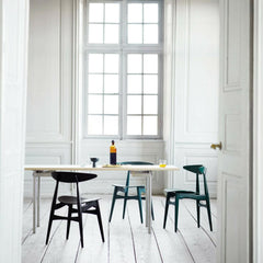 Wegner CH33 dining chairs in room with dining table Carl Hansen and Son