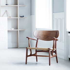 Wegner CH22 Lounge Chair in Walnut in Room by Carl Hansen and Son