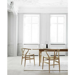 Wegner Wishbone Chairs in room with Wegner Dining Table and Woodlines Rug by Naja Utzon Popov